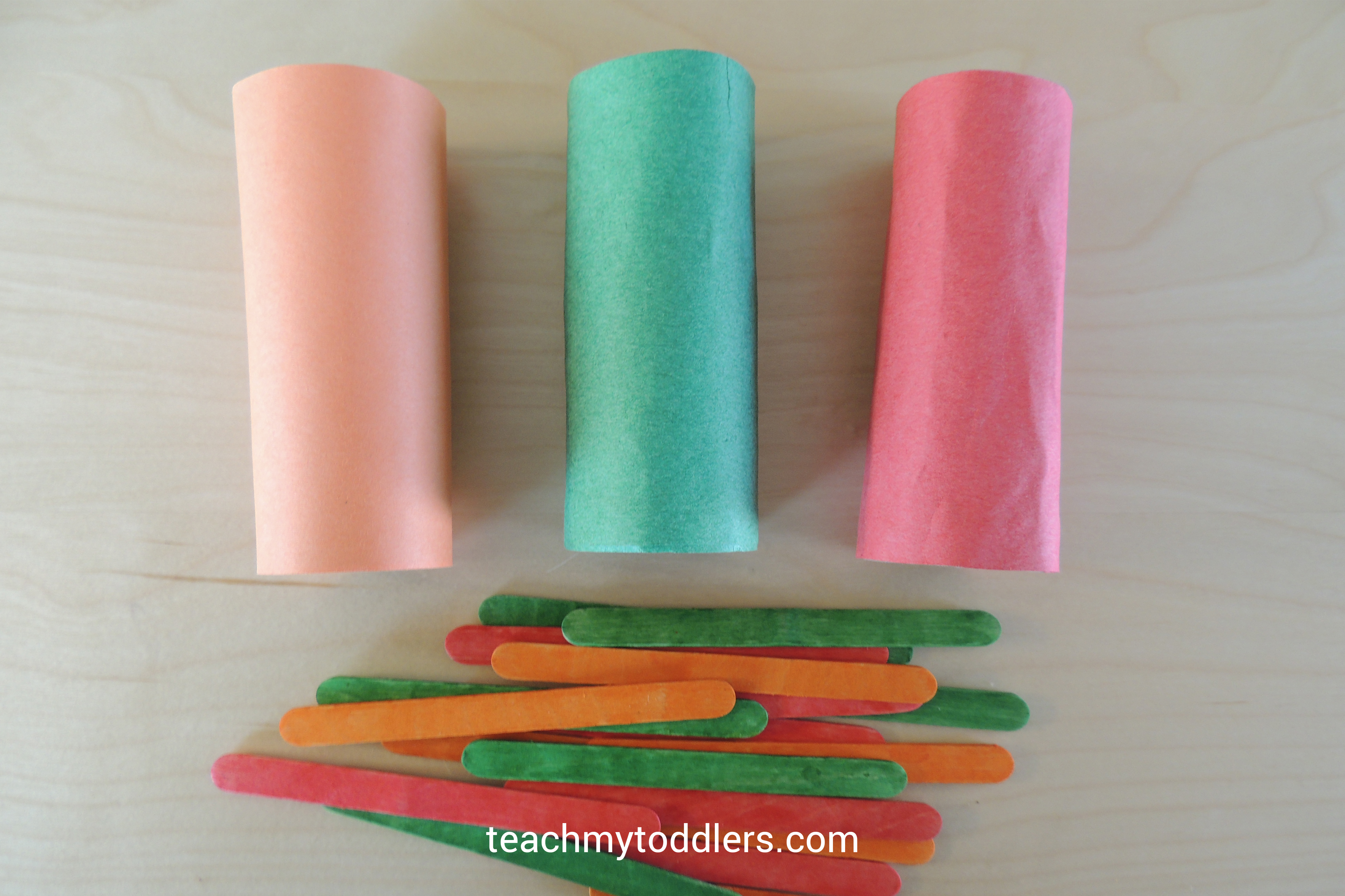 Paper tubes and colored popsicle sticks for general conference toddler games